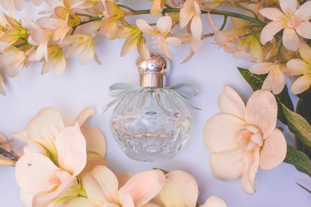 Perfume bottle with white flowers