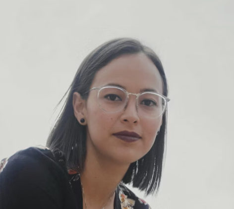 Woman wearing glasses smiling confidently